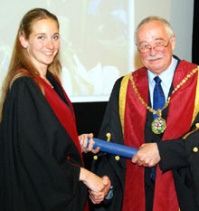 Dr Annamaria Nagy receives the scroll of Fellowship by Thesis from Jerry Davies