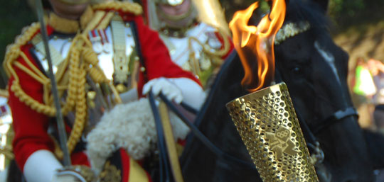 The Olympic flame accompanied by the Household Cavalry in Westminster yesterday