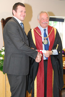 Dr Jerry Davies presents an RVN certificate and badge to James Osborn