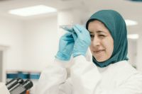 Female vet examines evidence in a laboratory