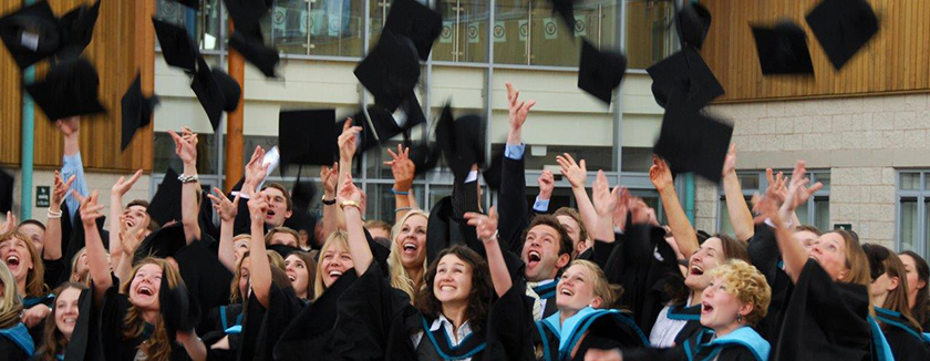 Graduates throwing caps in air