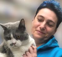 Justyna Borkowska-Rozanska holding a grey and white cat