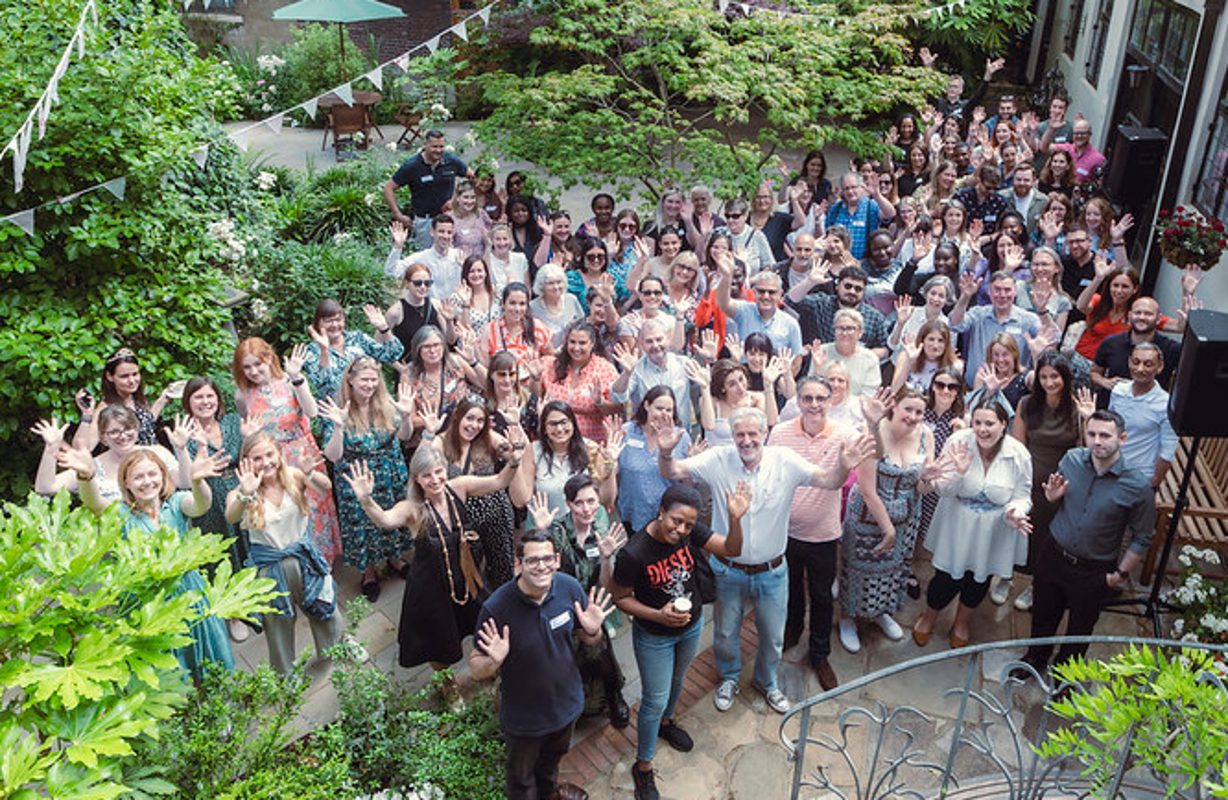 RCVS staff on the 2023 away day, standing in a garden and waving.