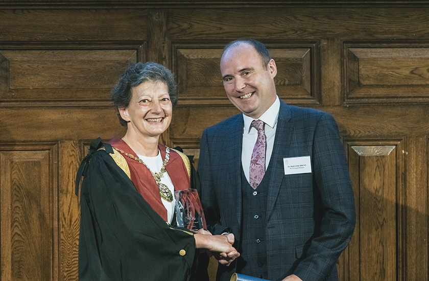 Mark Little receiving the 2023 Impact Award from Melissa Donald 