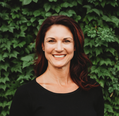 A woman wearing a black top smiling