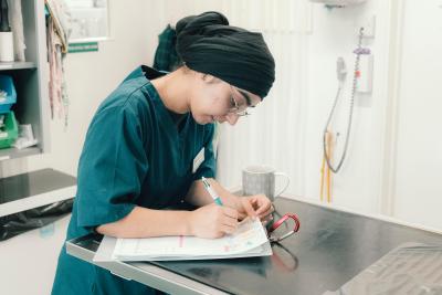 Vet from Wendover Heights surgery writing notes
