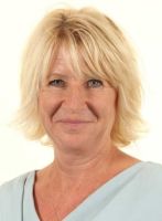 Portrait of Professor Nicola Spalding, smiling, with short blonde hair and wearing a light blue top.