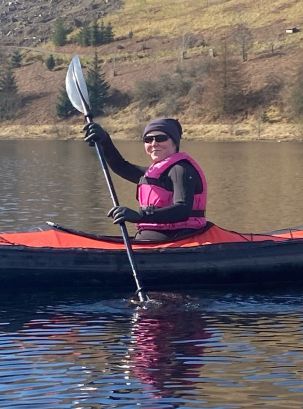 Veterinary anaesthetist Rachel kayaking on a lake