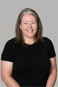 A woman wearing a black t-shirt smiling