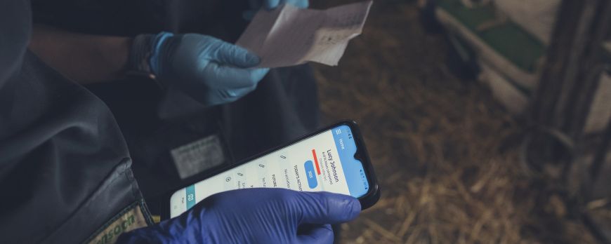 Close up of mobile phone in barn setting 