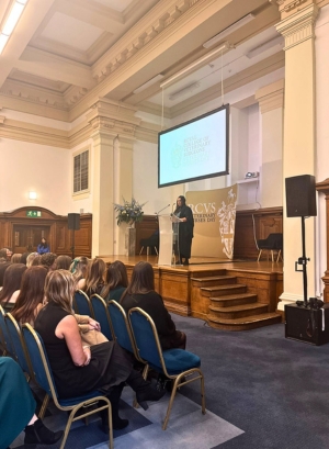 VN Day ceremony - Jasmine Curtis hosting on stage with RVNs sat in front on chairs