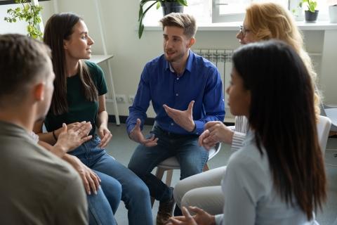 People sat in a circle in discussion