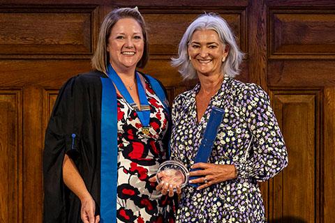 Belinda Andrews-Jones awarding the VN Golden Jubilee Award to Perdita Welsh 