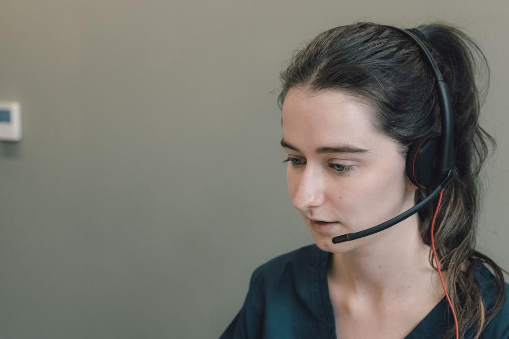 A woman speaking on a headset 