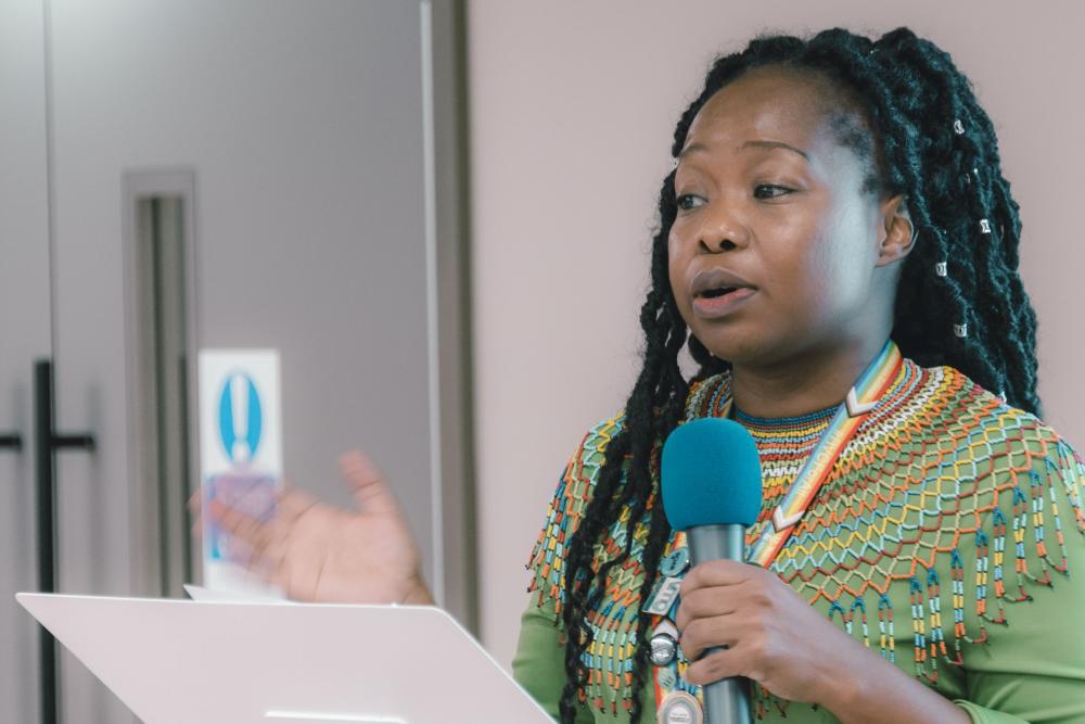 A woman presenting at an event 