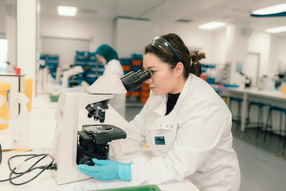 Student Vet looking through a microscope