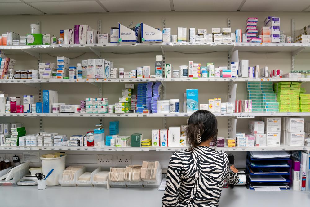 A practice staff member in front of a veterinary dispensary 