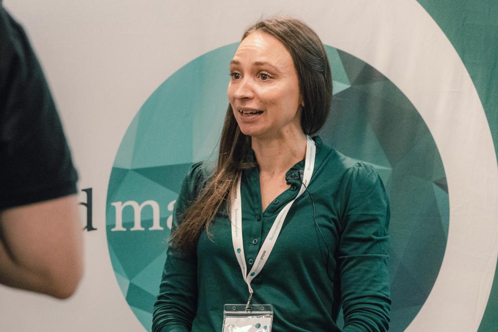 A person standing in front of a Mind Matters Initiative logo