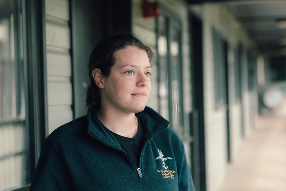 Equine vet stands by stable doors