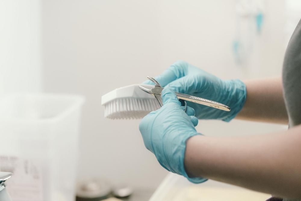 The hands of a student vet nurse washing a clinical brush