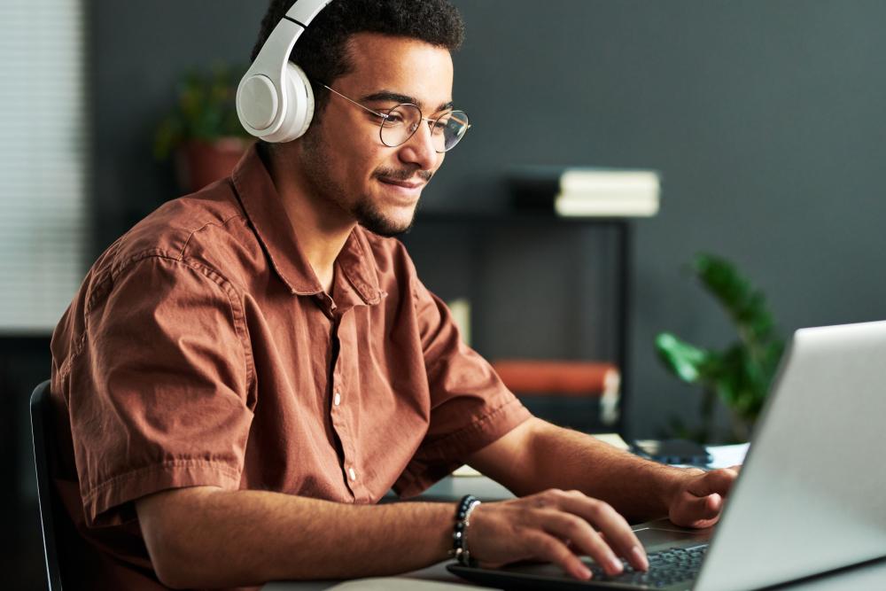 Man wearing headphones working at a computer