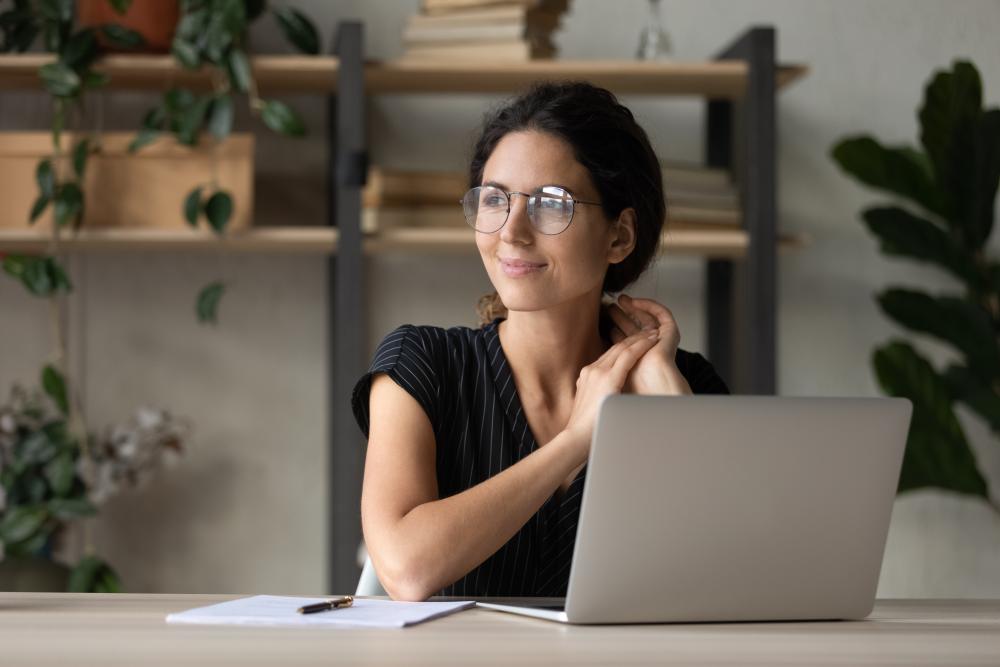 A woman sitting in front of a laptop