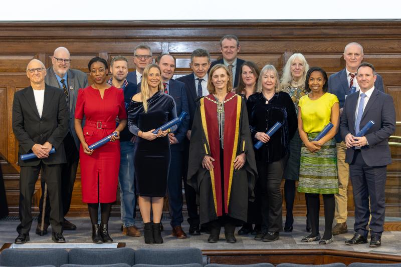 Group of RCVS Fellows smiling and holding scrolls